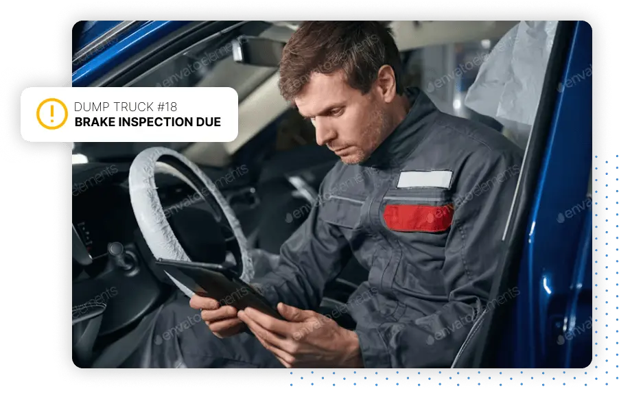 Person looking at an alert, sitting in a vehicle